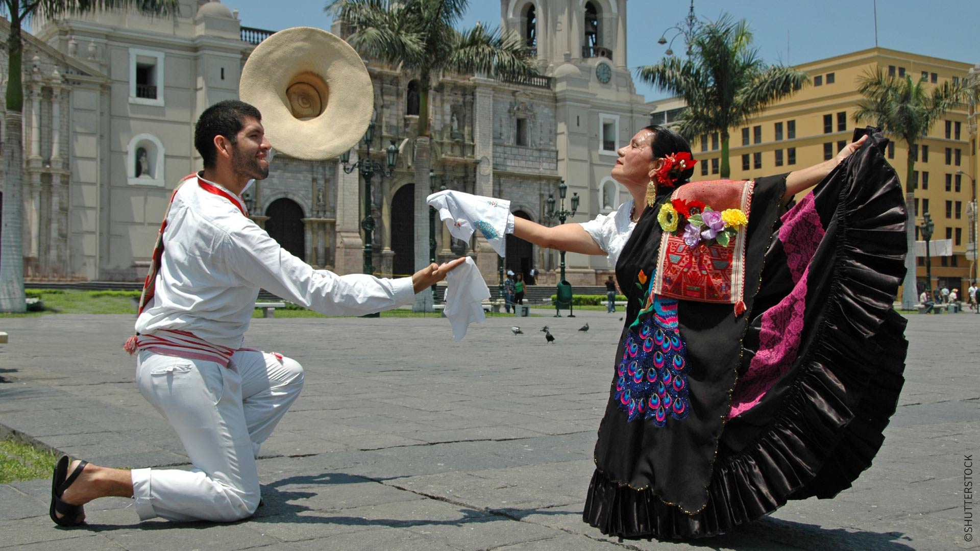 A couple dancing the marinera in a Lima plaza